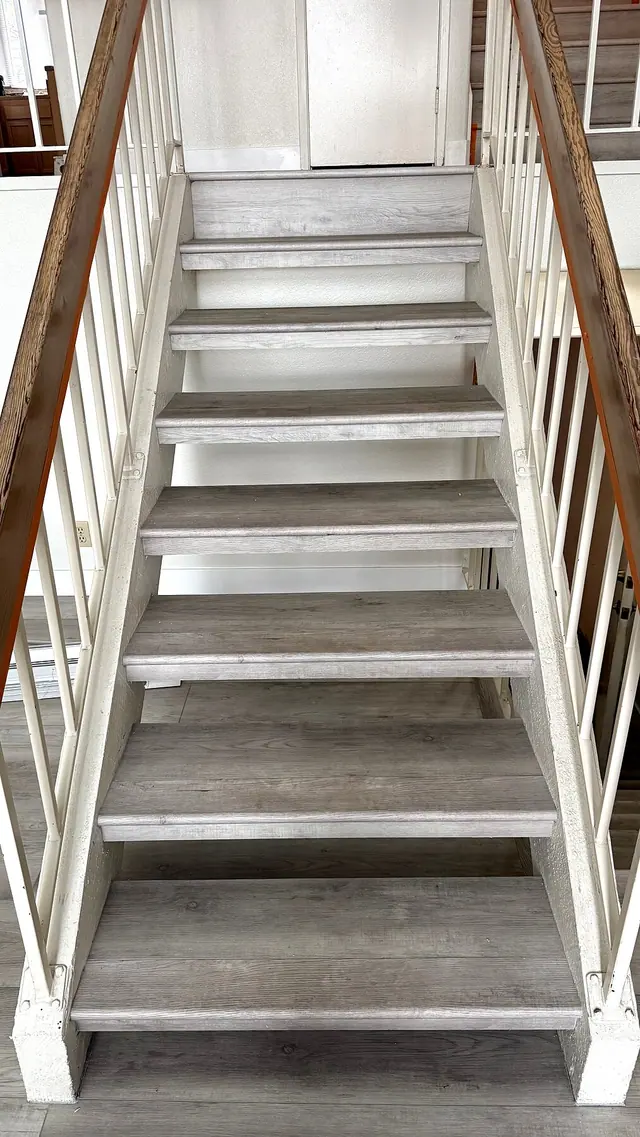 Staircase flooring with gray wood treads by Grain and Stain Renovations in Hendersonville TN