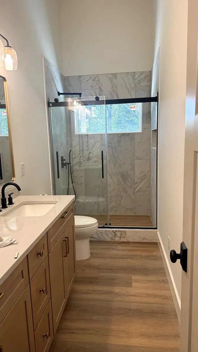 Bathroom remodel with vanity walk in shower and wood flooring by Grain and Stain Renovations in Hendersonville TN