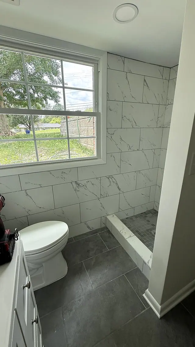 Bathroom remodel with window toilet and tile wall by Grain and Stain Renovations in Hendersonville TN