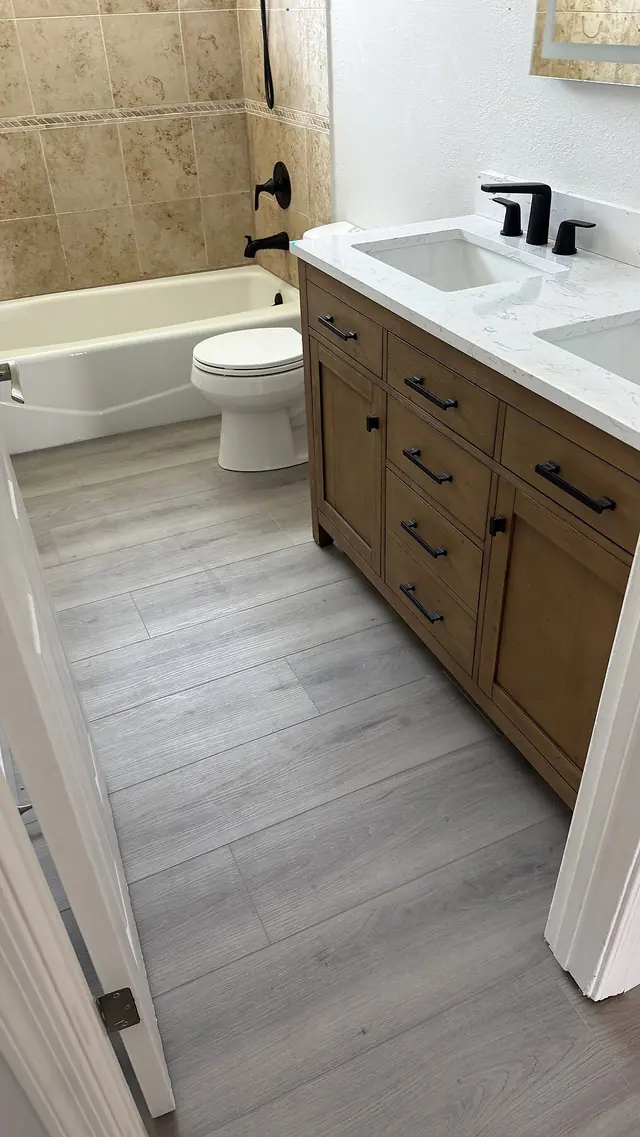 Bathroom vanity tub and gray LVP flooring remodel by Grain and Stain Renovations in Hendersonville TN