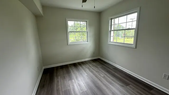 Finished interior room with painted walls, white trim, and new flooring by Grain and Stain Renovations in Hendersonville TN