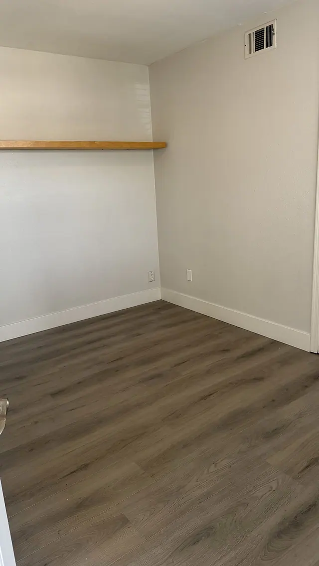 Bedroom gray LVP flooring with fresh painted walls by Grain and Stain Renovations in Hendersonville TN