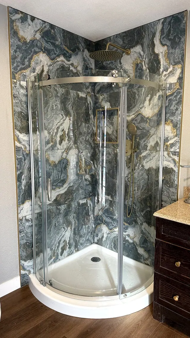 Corner shower remodel with dark marble tile by Grain and Stain Renovations in Hendersonville TN