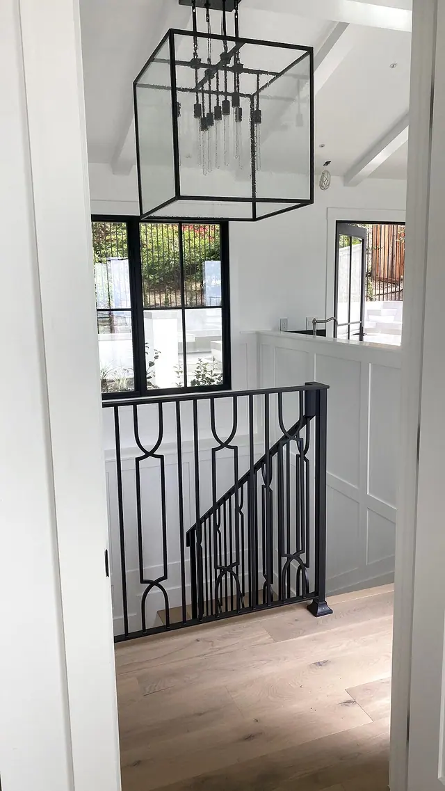 Custom black stair railing and wood floor landing by Grain and Stain Renovations in Hendersonville TN