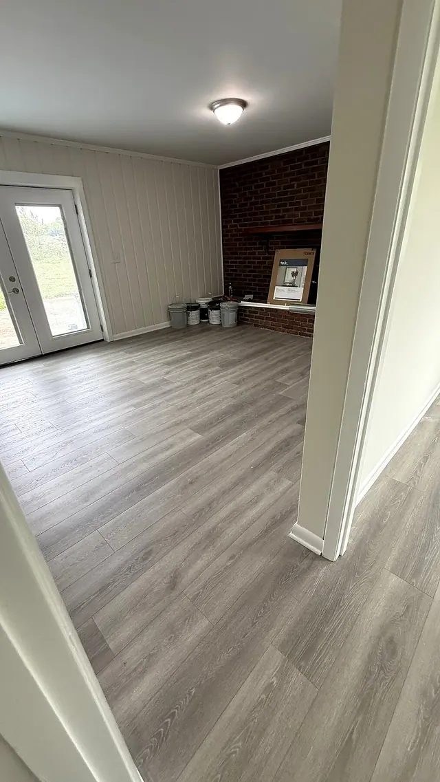 Luxury vinyl plank flooring installation in a living room by Grain and Stain Renovations in Hendersonville TN