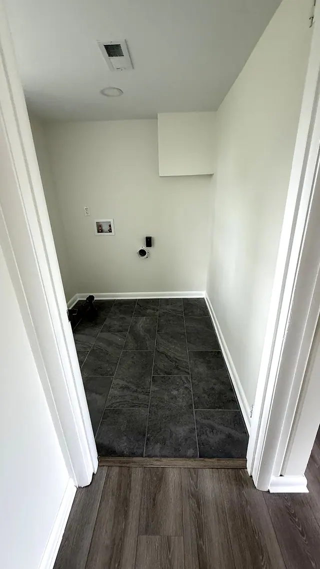 Laundry room gray tile and LVP floor transition by Grain and Stain Renovations in Hendersonville TN