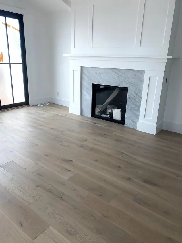 Light oak flooring and fireplace trim remodel by Grain and Stain Renovations in Hendersonville TN