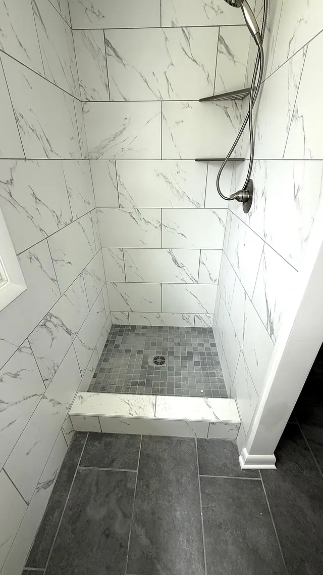 Walk in shower tile installation with gray floor by Grain and Stain Renovations in Hendersonville TN