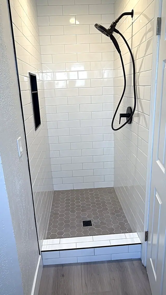 White subway tile shower with black fixtures by Grain and Stain Renovations in Hendersonville TN