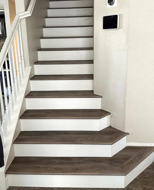 Wood stair tread installation with white risers by Grain and Stain Renovations in Hendersonville TN