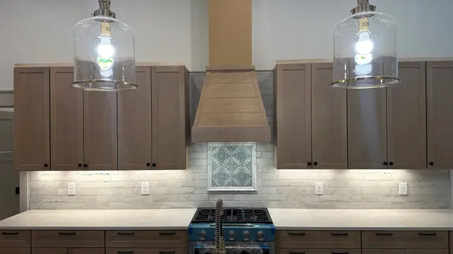 Kitchen remodel with custom range hood, tile backsplash, and cabinet updates by Grain and Stain Renovations in Hendersonville TN